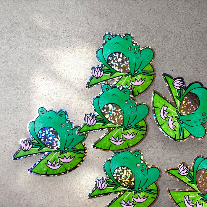a group of angry froggy stickers with a glittery border and belly