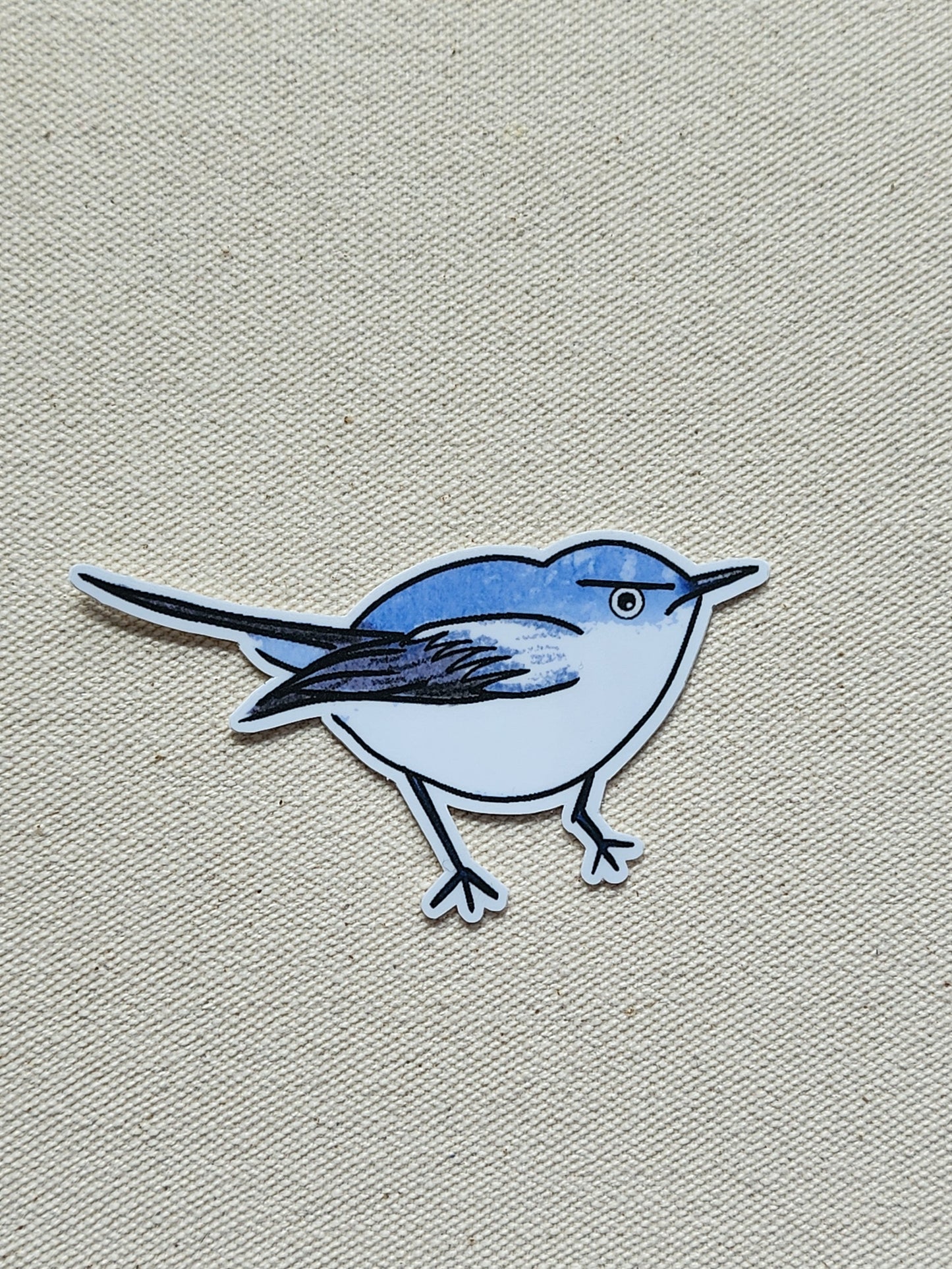 Sticker of a blue bird on a beige textured background