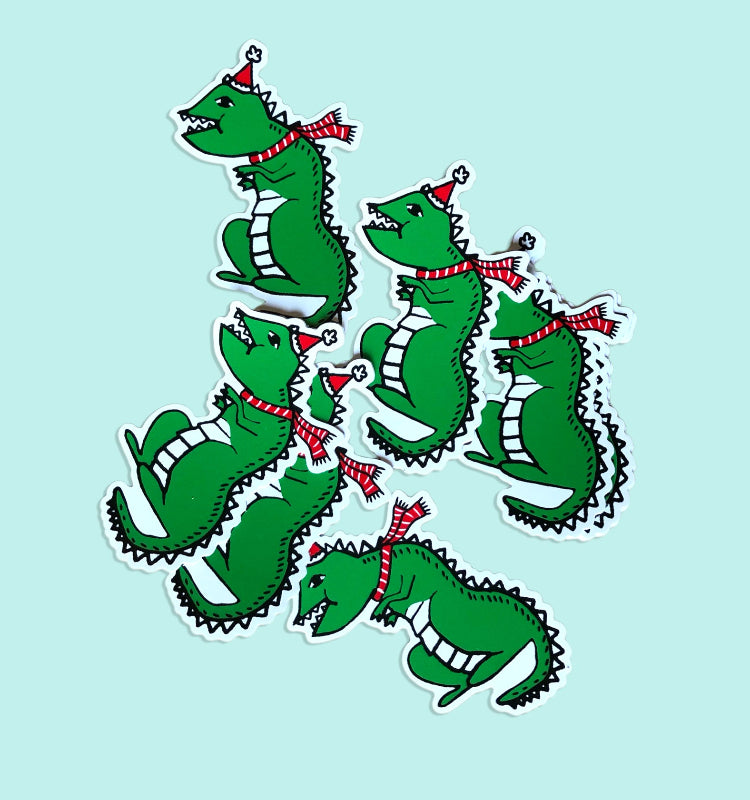 a pile of festive dino stickers against a blue background