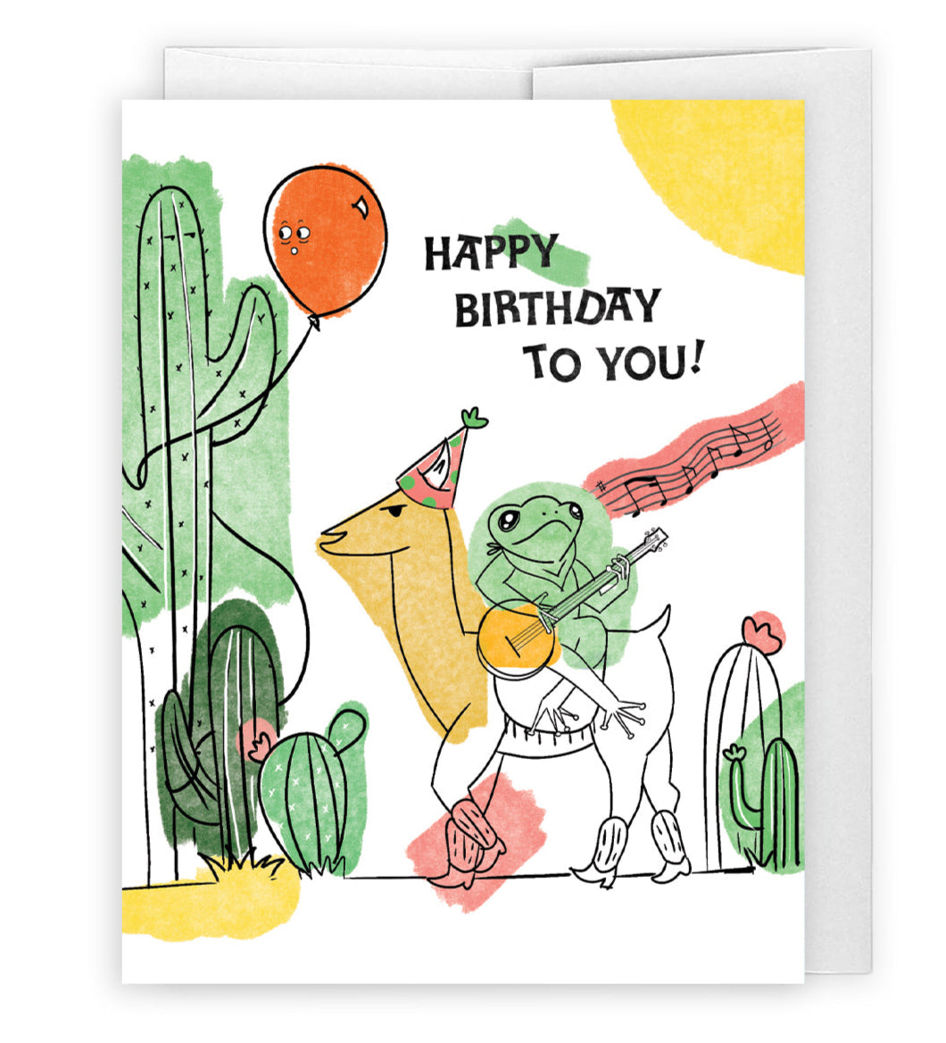 Froggy Llama Birthday Drama card, featuring a quirky frog riding a llama in a mexican desert. Perfect for sending a super fun birthday message to friends and loved ones.