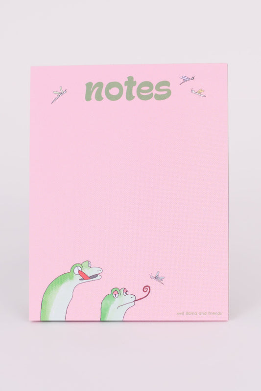 a pink notepad showing 2 cartoon geckos on the bottom, with their tongues out, catching fireflies. the text on top reads "notes" in green