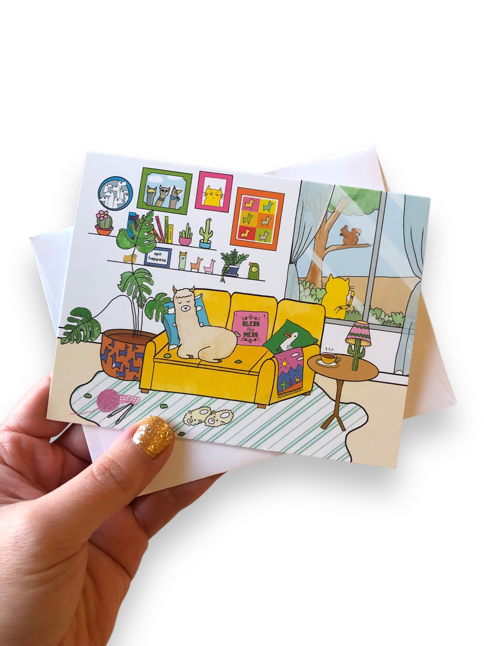 napping llama card in hand, with white envelope, to show scale