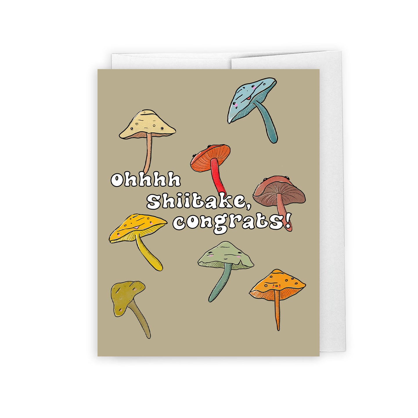 a cute congratulations card showing a bunch of shiitake mushrooms in earth colour tones. the text reads "oh shiitake, congrats!". the card is placed against a white envelope