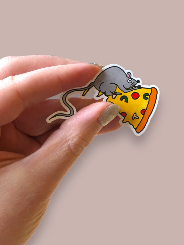 pizza rat sticker in hand to show scale