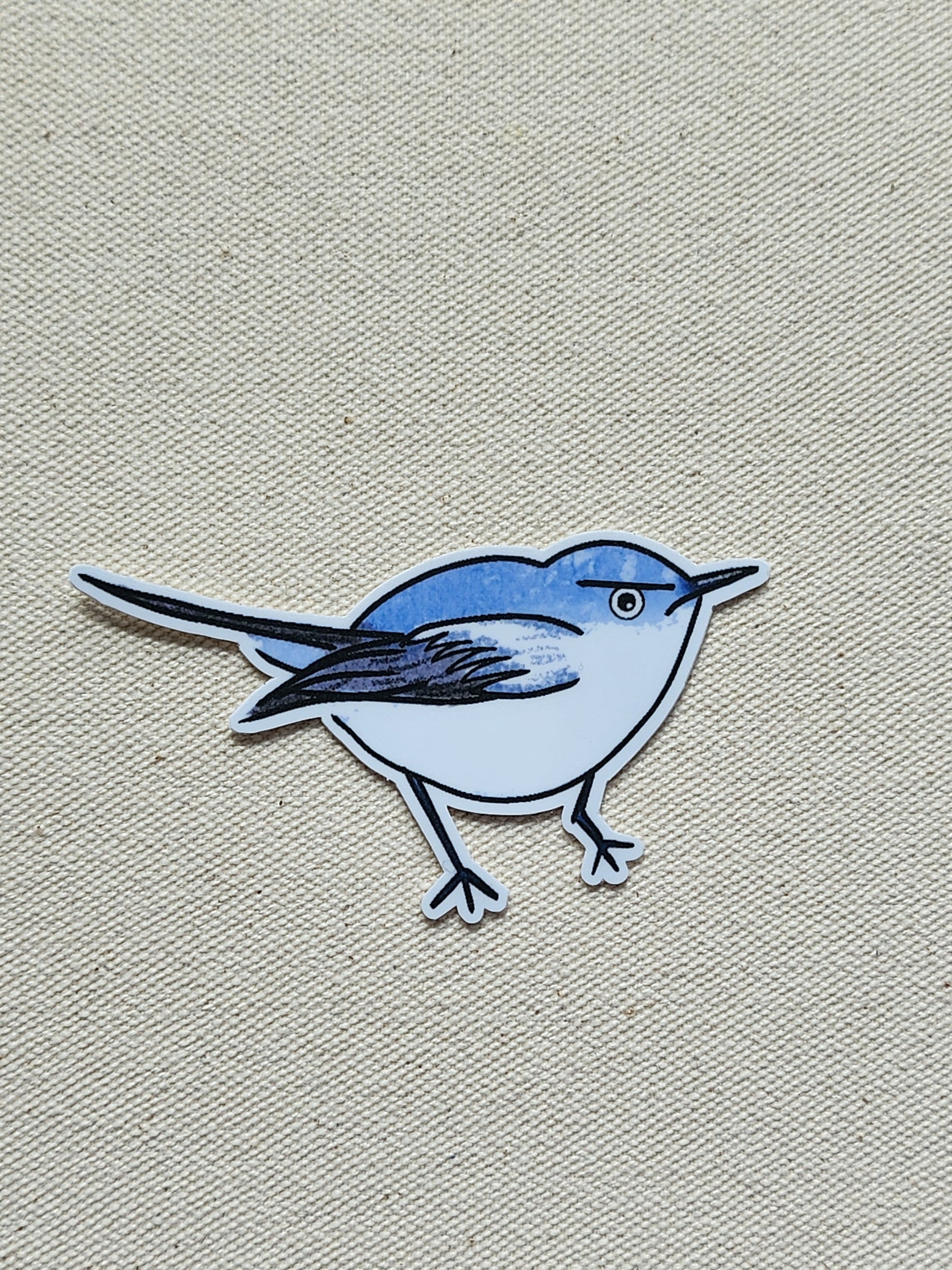 Sticker of a blue bird on a beige textured background