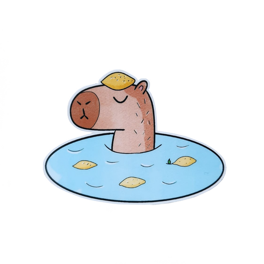 sticker of capybara in onsen with lemons around against a white background