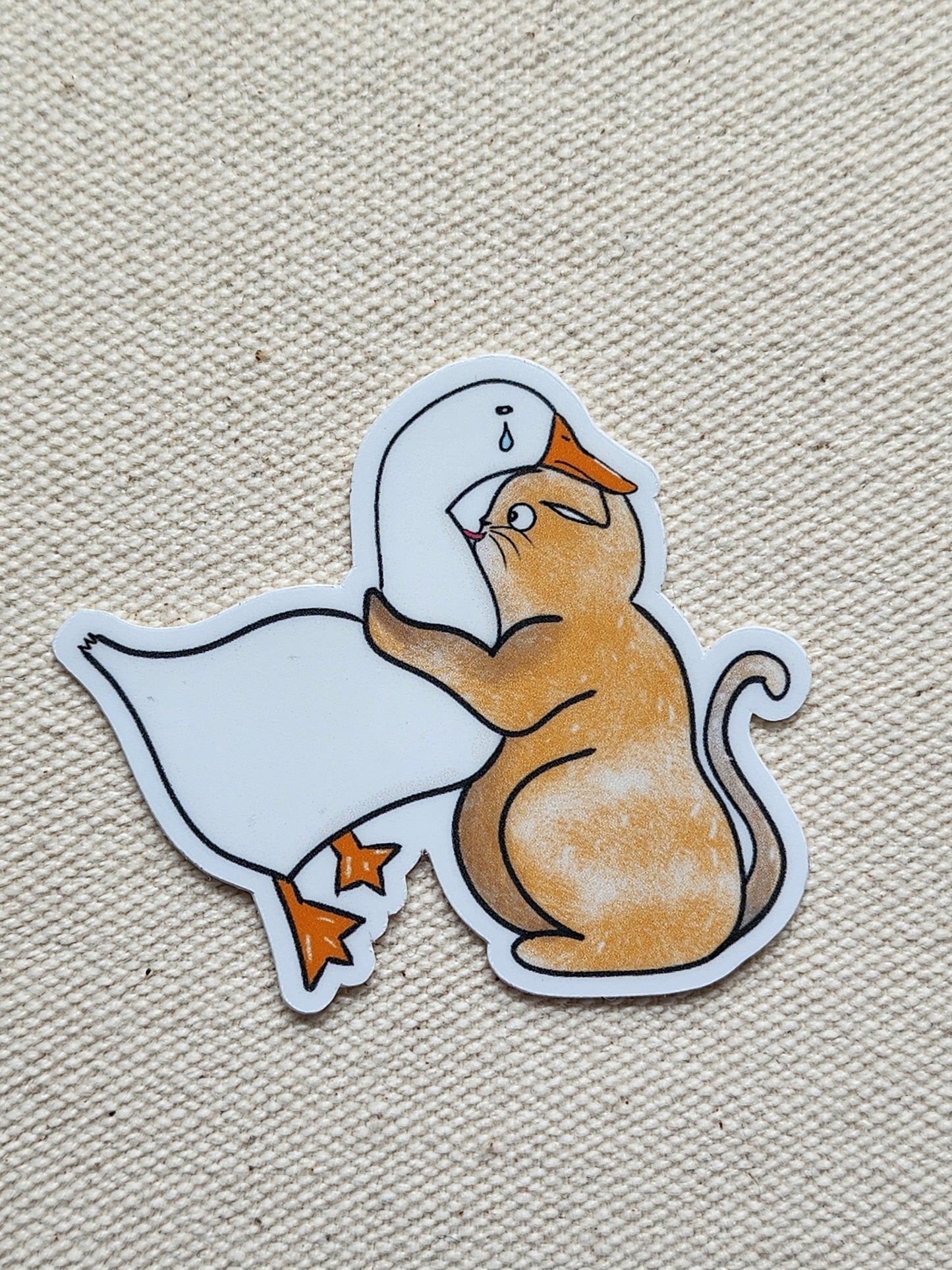 cat and duck sticker on a textured beige background