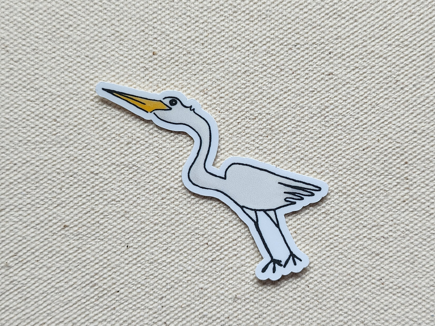 egret bird sticker on a beige, textured background