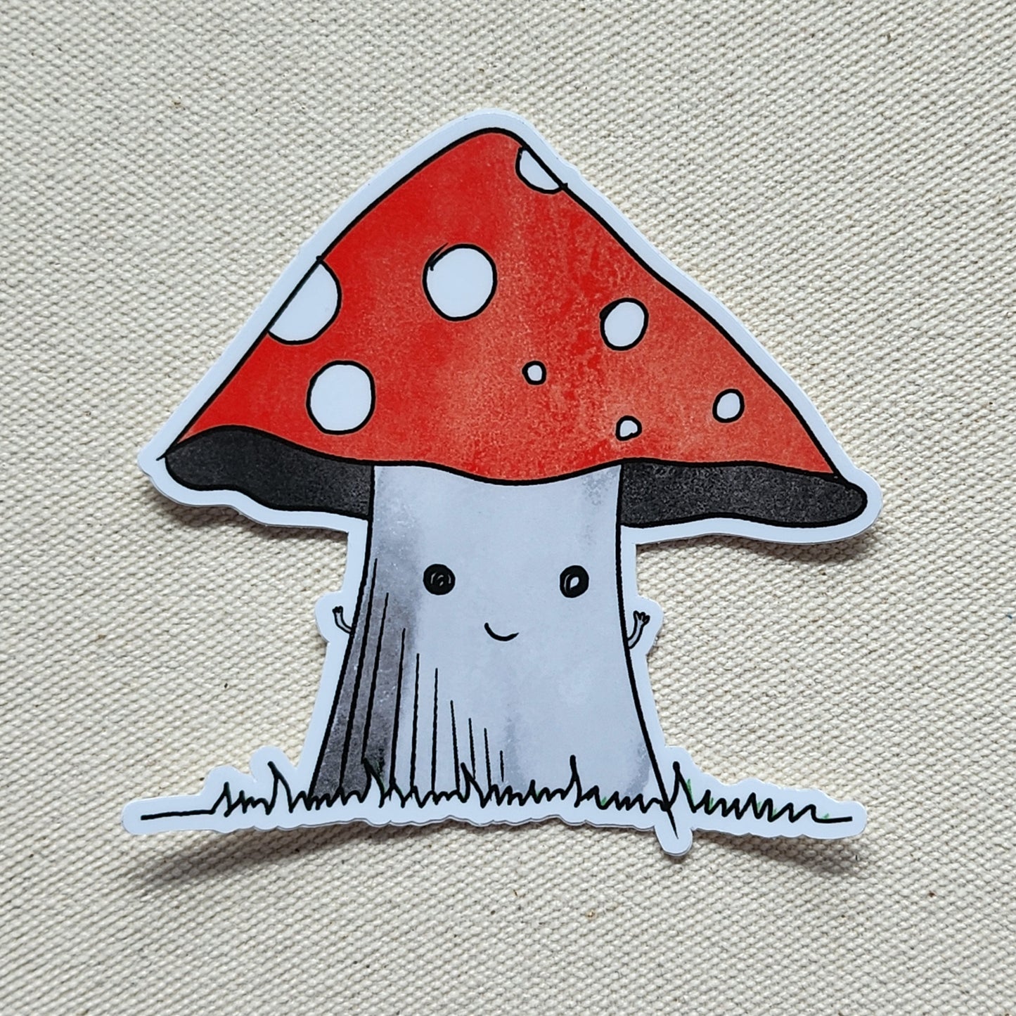 happy mushroom sticker on a beige, textured background