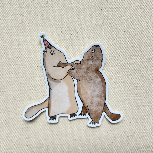 sticker of 2 marmots with a party hat on a beige textured background