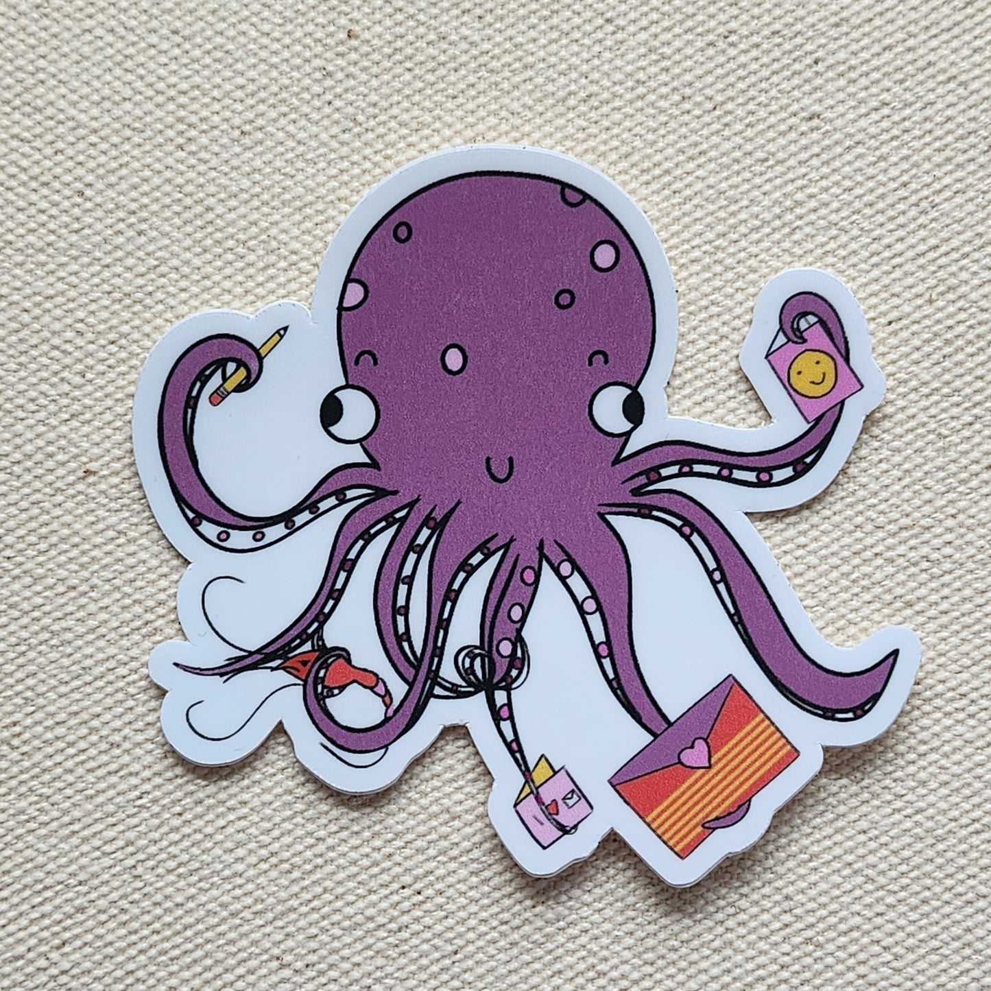 purple octopus sticker on a beige textured background