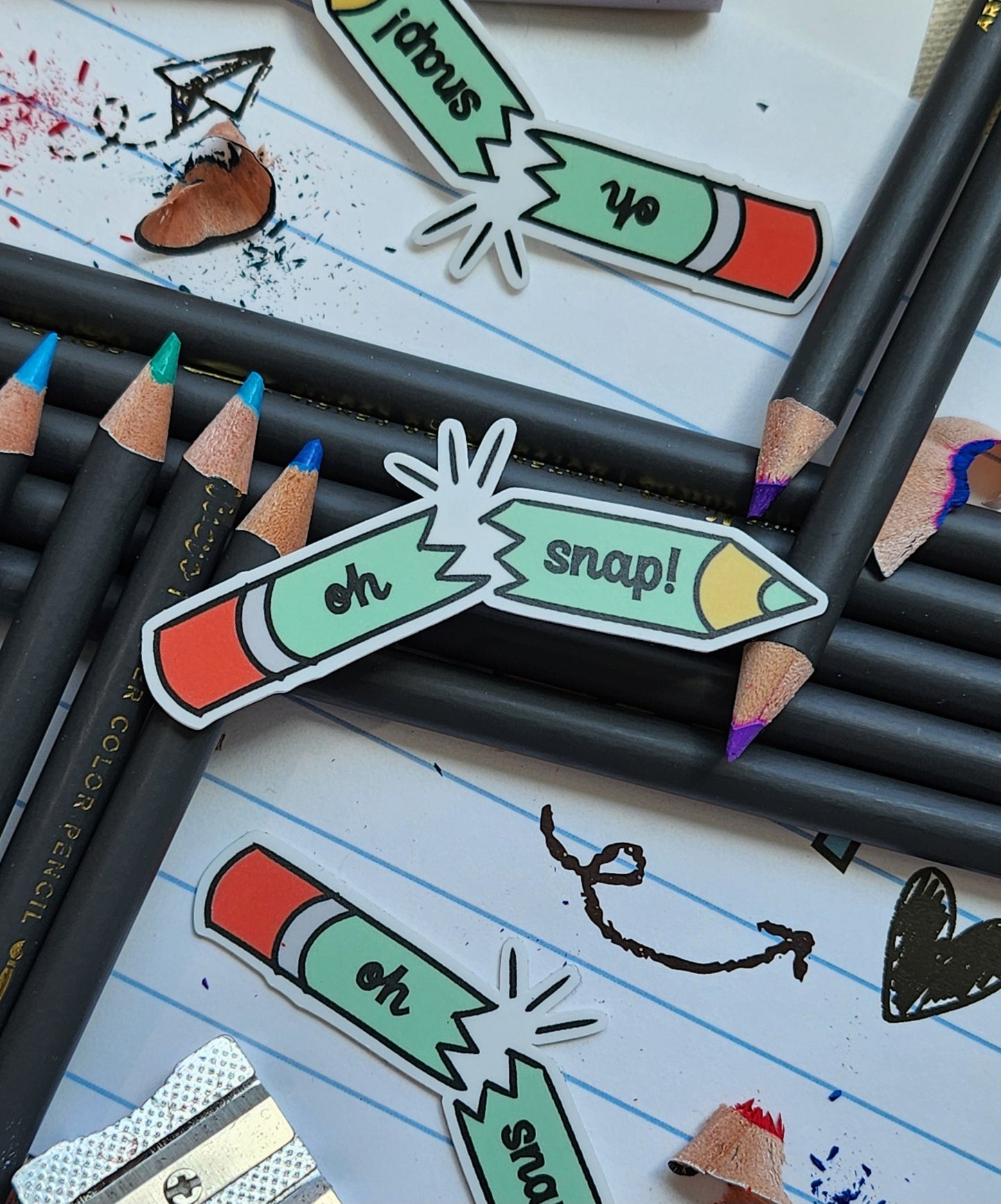 pencil stickers styled on colouring pencil, on top of a lined paper with doodles