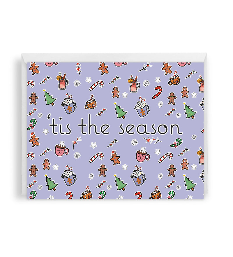 a cheerful holiday card showing various elements such as candy canes, gingerbread cookies, hot cocoa mugs, and christmas trees. the text in the middle reads "'tis the season". the card is placed against a white envelope